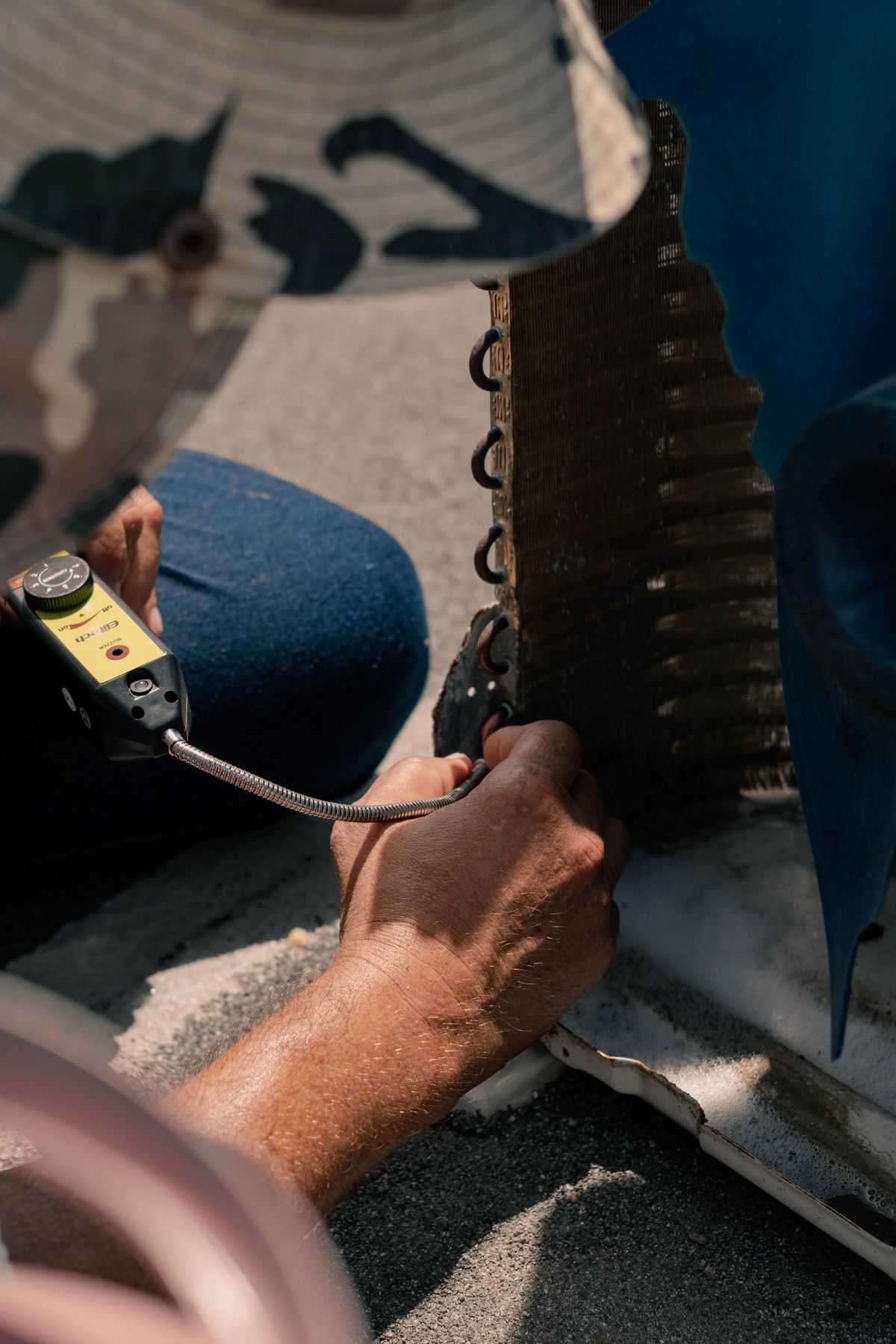 HVAC technician repairing an outdoor air conditioning unit